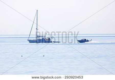 Grisslehamn, Sweden - Jul 15, 2018: One Sailship And One Motor Boat On The Blue Ocean In The Swedish