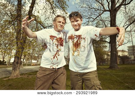 Men In Street Park Fighting After Eating Langos With Garlic, Ketchup And Cheese