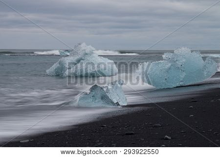 Amazing Transparent Blue Iceberg Pieces On Diamond Beach With Black Sand Near Jokulsarlon Lagoon, Ic