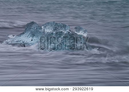 Amazing Transparent Blue Iceberg Pieces On Diamond Beach With Black Sand Near Jokulsarlon Lagoon, Ic