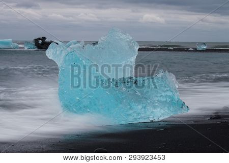 Amazing Transparent Blue Iceberg Pieces On Diamond Beach With Black Sand Near Jokulsarlon Lagoon, Ic