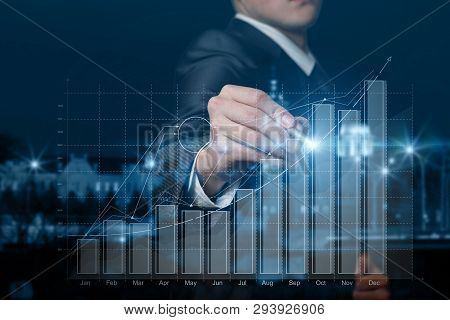 A Businessman Is Operating With The Growth And Increase Diagram At The Background Of Night City Pano
