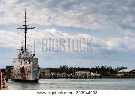 Coast Guard Cutter Ingham Docked At Key West Harbor With Dramatic Sky