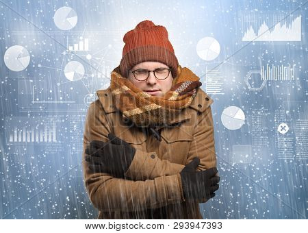 Young businessman shivering with graphs, reports and chart concept