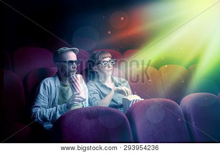 Teenager couple cuddling and watching the climax part of the movie