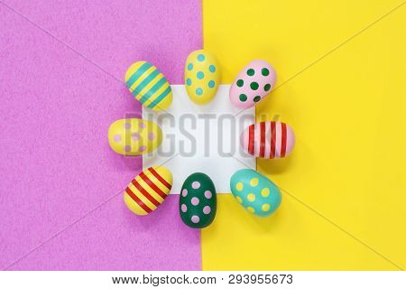 Brightly Coloured Easter Eggs Around A Blank White Square, On A Pink And Yellow Background