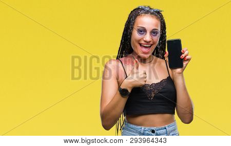Young braided hair african american with birth mark showing smartphone screen over isolated background happy with big smile doing ok sign, thumb up with fingers, excellent sign