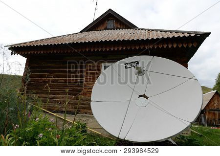 Altai Region, Russia - September 4, 2018: Satellite Dish Near The House In The Mountainous Siberian 