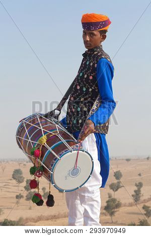 Bikaner, India - January 12, 2019: Indian Drummer In Traditional Clothes Performing During Camel Fes