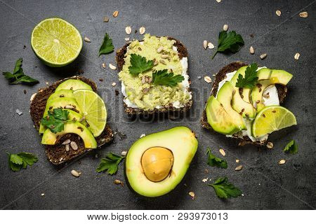 Avocado Sandwich With Seeds And Cream Cheese. Black Slate Background, Top View.
