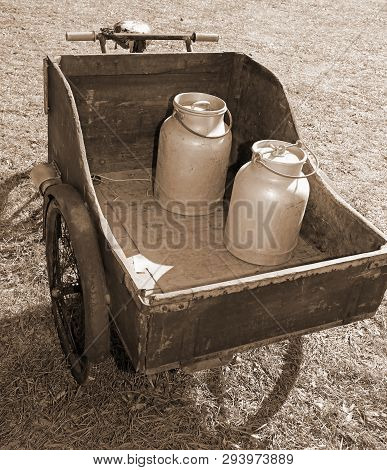 Ancient Bicycle Used By The Milkman For Transporting The Milk Can With A Wooden Cart