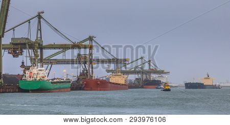 Nautical Bulk Carrier Ships In Iron Ore Harbour At Rotterdam Port, The Netherlands