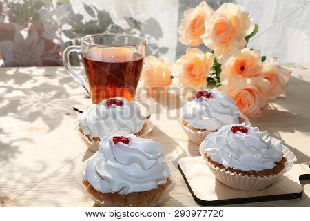 A Cup Of Tea And A Cake On A Sunny Table, A Bouquet Of Spring Flowers For Mood, Diet Food And A Heal