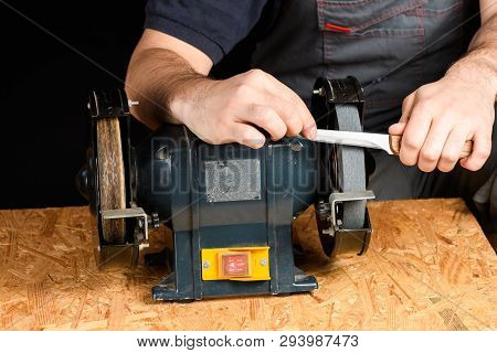 A Man In Working Clothes Hones Professional Sharpening Kitchen Knives