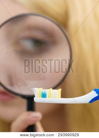 Beautiful Perfectionist Young Woman Checking Her Tooth Brush Through Manifying Loupe Glass. Hygiene,