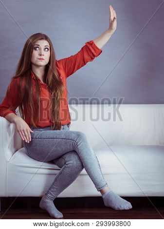 Angry, Pissed Off Young Woman. Attractive Female With Long Brown Hair Sitting On Sofa Being Mad And 