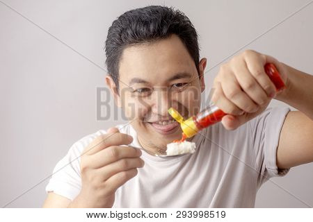 Asian Man Eating Rice With Sambal Chili Sauce