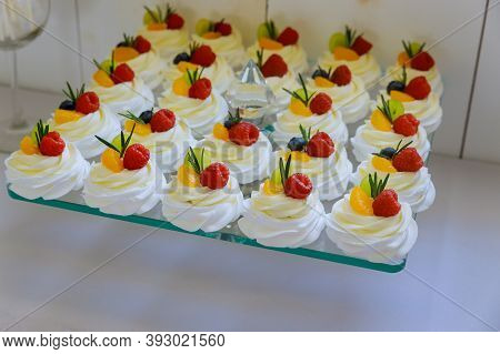 Mini Pavlova Cakes With Whipped Cream And Fresh Fruits. Mini Dessert.