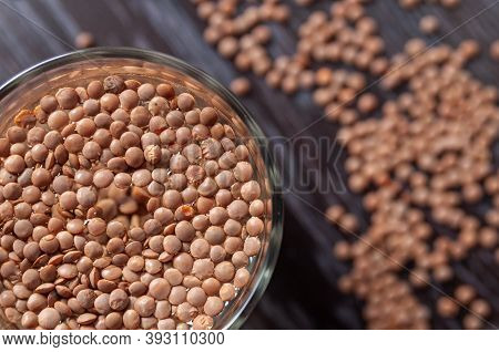Top View On The Lentils Are Soaked In A Glass Of Water.