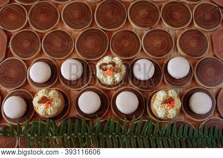 White Delicate Lowly Macaroons On A Wooden Background. The Pastel Tone Of The Cream Inside The Frenc