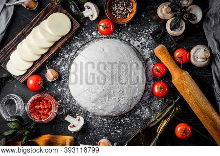 Ingredients For Making Pizza Dough, Mozzarella Cheese, Tomatoes, Mushrooms, Olive Oil And Basil On A