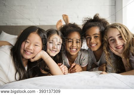 Large Group Of Her Friends Taking Goog Time On Bed