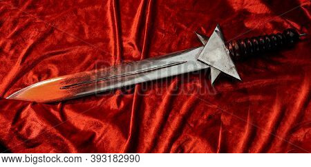 Flawless Short Roman Sword Its On Red Cape. Single Bronze Gladius On Floor Its Using By Imperial Leg