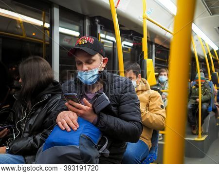 Moscow. Russia. October 27, 2020. A Young Man In A City Bus Looks Carefully At The Smartphone Screen