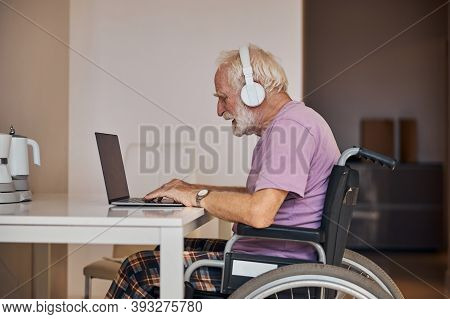 Focused Senior Caucasian Man Using His Computer
