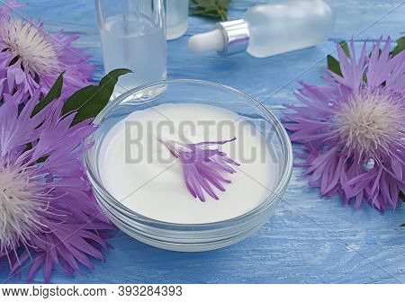 Cream Cosmetic Flower On Wooden Background Essence