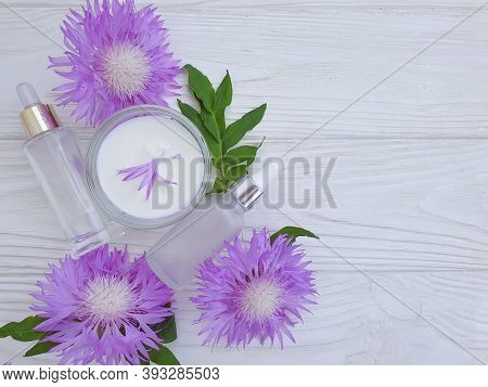 Cream Cosmetic Flower On Wooden Background Essence