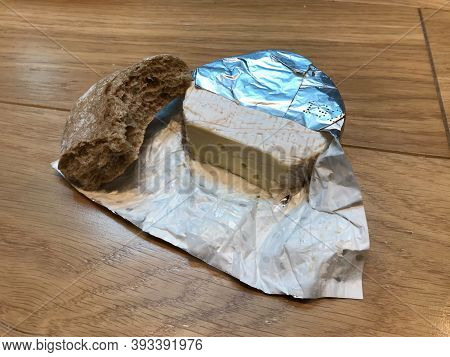 Fast Breakfast With Brie Cheese And Biten Rye Bread On Wooden Table Surface. Fast Food. Ready To Eat