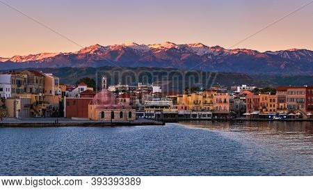 Sunrise View Of Old Venetian Harbour Of Chania, Crete, Greece, Its Quay Side. Great Cretan Mountains