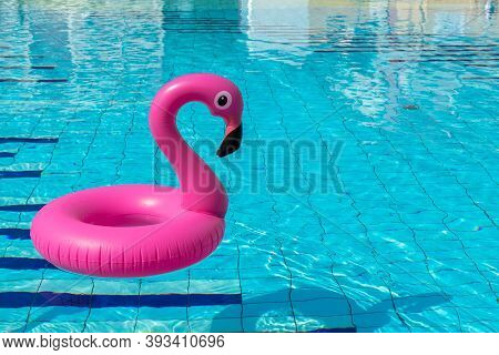 Pink Pool. Pink Inflatable Flamingo In Pool Water For Summer Beach Background. Pool Float Party.