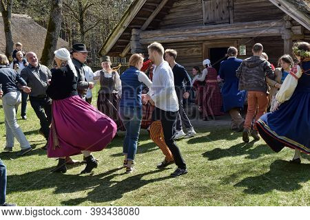 Latvian Culture Tradition. Midsummer In Latvia.. Folk Dance Group In Latvian Traditional Costume.
