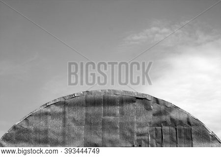 Roof Of Old Metal Hangar Against Sky. Architectural Background