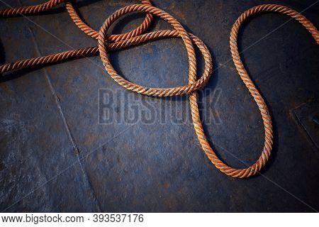 High Angle View Of The Old Giant Fiber Naytical Rope On Steel Boat Floor Background In Dark Tone Sty