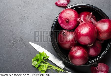 Red Ripe Onion In A Black Plate. Dark Background. Copy Space