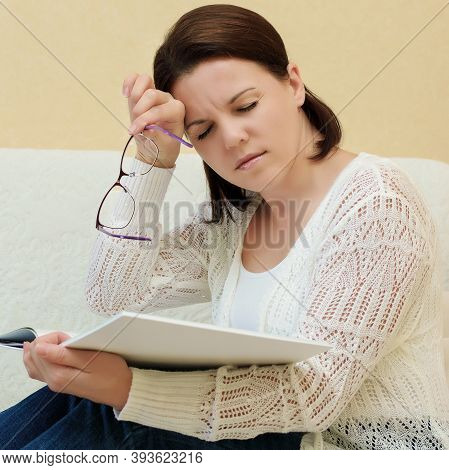 Woman With Glasses Suffering Eyestrain And Headache After Reading Book