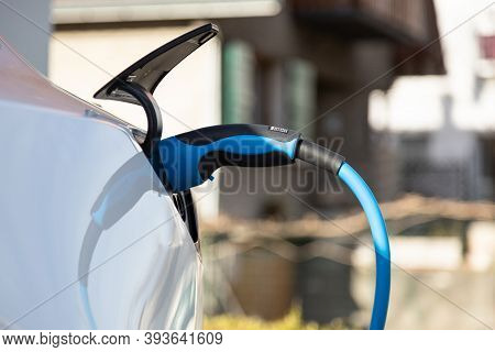 Ev Electric Car Pluged Charging At A Recharge Station In The City