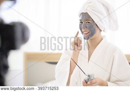 Video Camera Filming Woman In White Bathrobe Applying A Face Mask For Movie, Behind The Scenes Of Sh