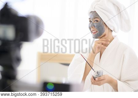Video Camera Filming Woman In White Bathrobe Applying A Face Mask For Movie, Behind The Scenes Of Sh