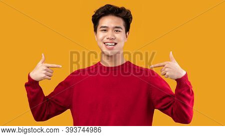 Choose An Pick Me. Self-assured And Charismatic Asian Man Pointing At Self, Wearing Red Sweater. Ego