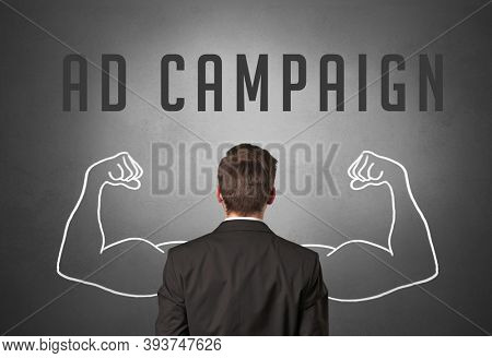 Rear view of a businessman with AD CAMPAIGN inscription, powerfull business concept