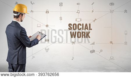 Engineer working on a new social media platform with SOCIAL WORK inscription concept