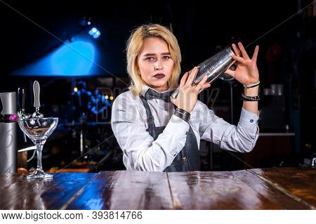 Pretty Woman Barman Decorates Colorful Concoction While Standing Near The Bar Counter In Bar
