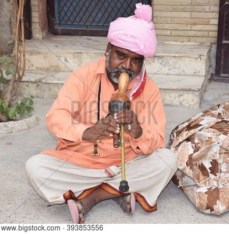 Delhi - India
9th Nov 2020
Indian Snake Charmer Performing With His Musical Instrument Also Called A