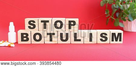 The Words Stop Botulism Is Made Of Wooden Cubes On A Red Background. Medical Concept.