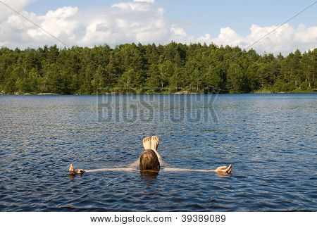 Person Lying In The Water For Recreation