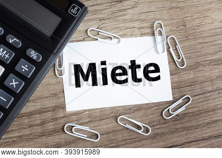 Miete, Text On White Paper On Gray Background